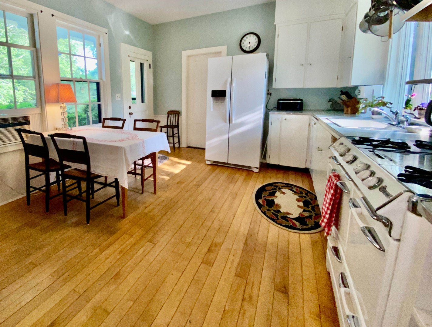 70 Spring Street Vineyard Haven, MA 02568 - Photo 25 of 68 a kitchen with a table chairs stove and cabinets