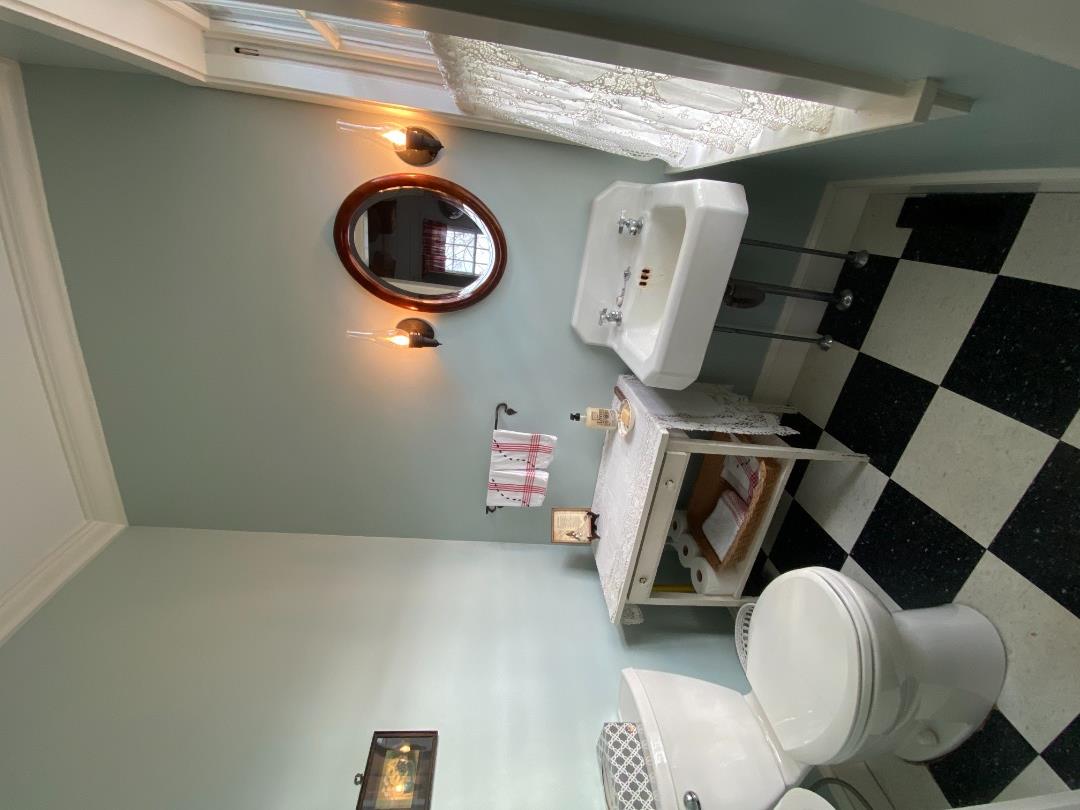 70 Spring Street Vineyard Haven, MA 02568 - Photo 30 of 68 a bathroom with a toilet a sink and a mirror