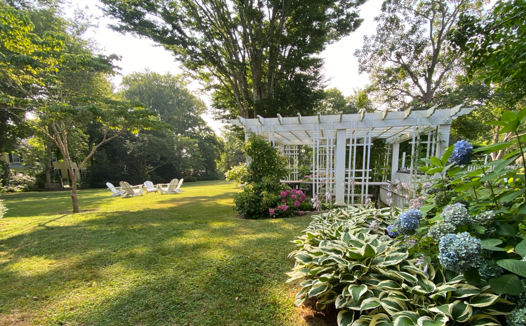 70 Spring Street Vineyard Haven, MA 02568 - Photo 35 of 68 a view of swimming pool with lawn chairs and large trees
