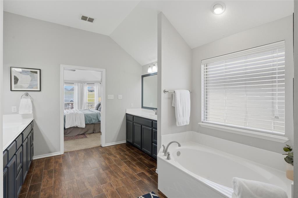 7224 Prestwick Terrace Benbrook, TX 76126 - Photo 14 of 26 a bathroom with a tub sink and a mirror