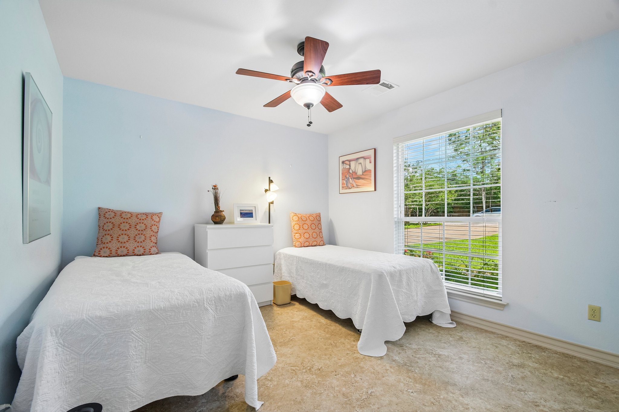 307 West 4th Street Elgin, TX 78621 - Photo 26 of 40 Bright room with light blue walls, a large window, a ceiling fan with light fixture, and neutral-toned flooring