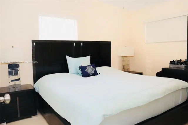 a bedroom with a bed and a night stand