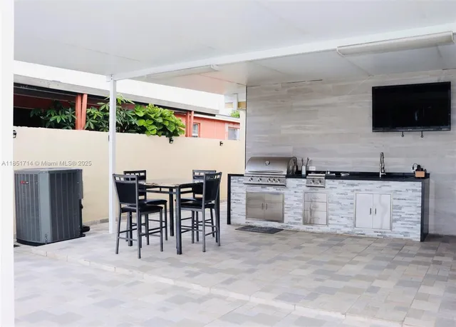 a view of kitchen with sink microwave and refrigerator