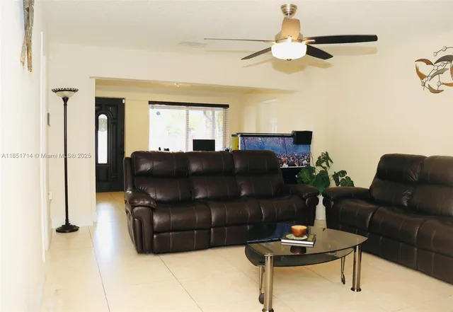 a living room with a couch and a chandelier