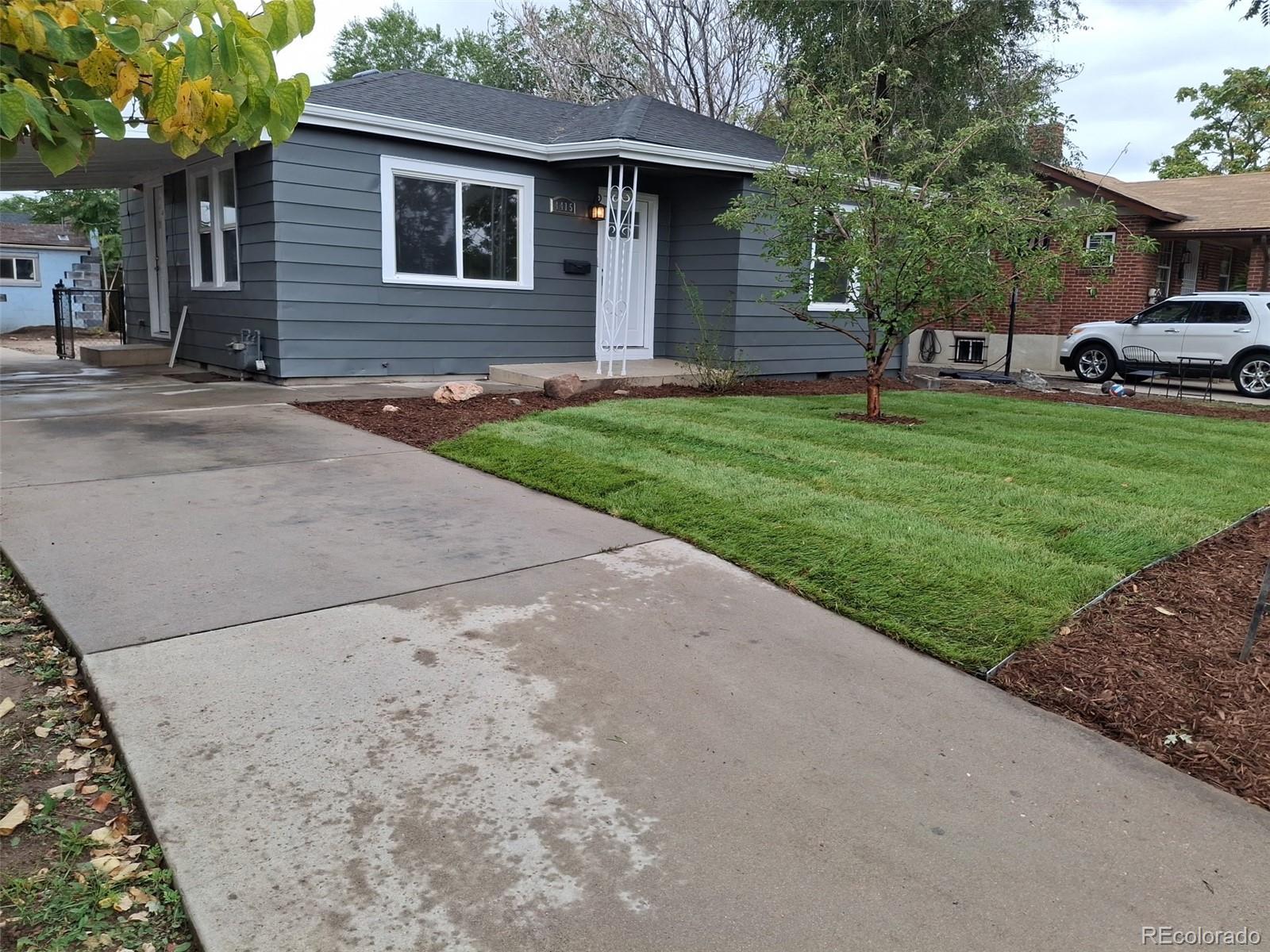 a view of a house with a yard and tree s