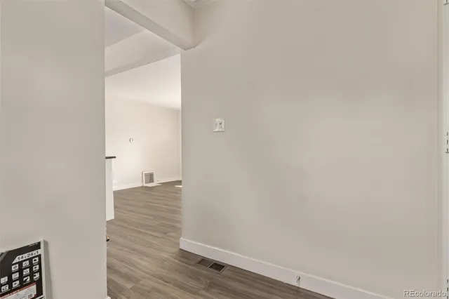 a view of a room with wooden floor