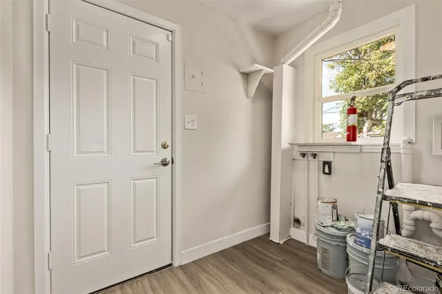 a view of a hallway with wooden floor and entryway