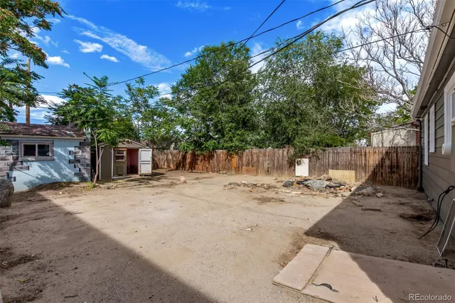 a view of a backyard with a tree