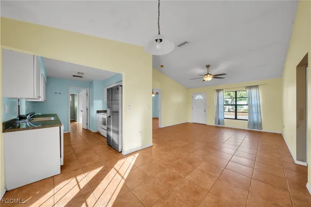a view of a kitchen with a sink and a window
