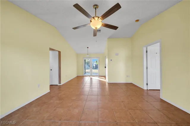 a view of an empty room with a ceiling fan