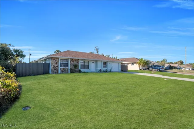 a front view of a house with a garden