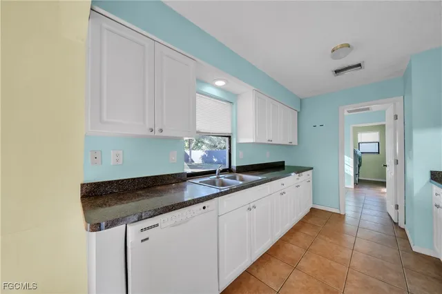 a kitchen with granite countertop a sink and cabinets