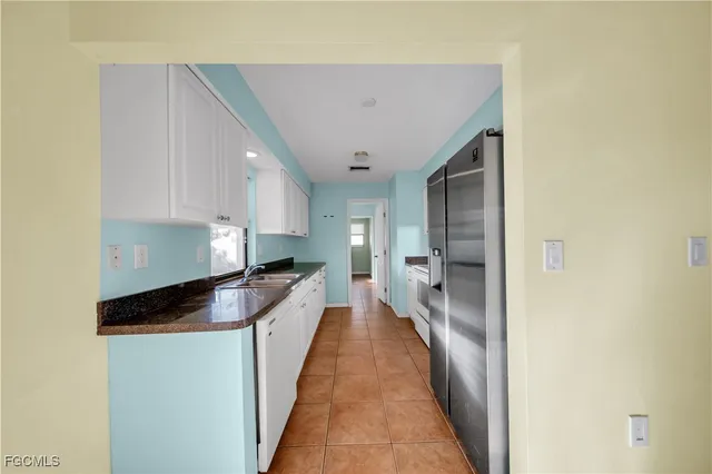 a view of a kitchen with a sink and cabinets