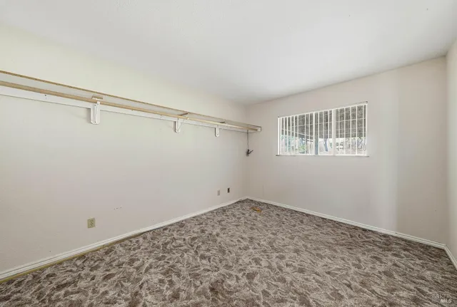 a view of a big room with closet and wooden floor