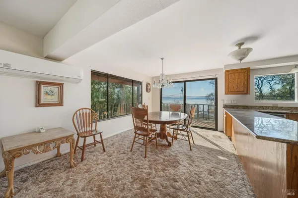 a large kitchen with stainless steel appliances granite countertop a large window a sink and cabinets