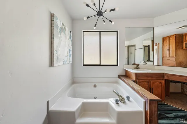 a kitchen with stainless steel appliances granite countertop a sink and a refrigerator