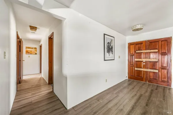 wooden floor in an empty room with a window