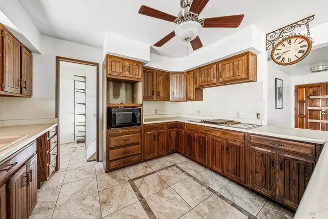 a view of backyard with plants and wooden fence