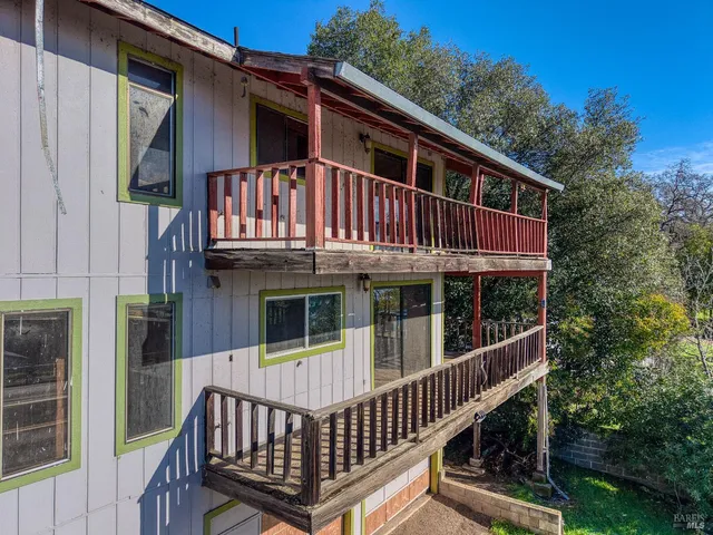 a view of a house with a wooden deck