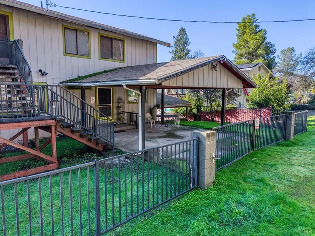 a front view of house with yard and green space