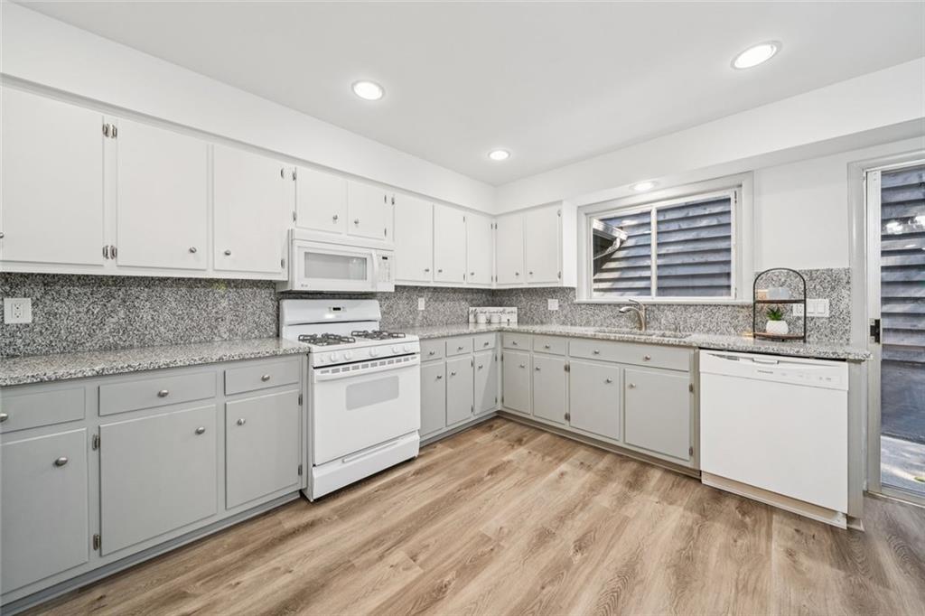 230 Lakeview Ridge East Roswell, GA 30076 - Photo 19 of 70 a kitchen with granite countertop white cabinets white stainless steel appliances with a sink and dishwasher