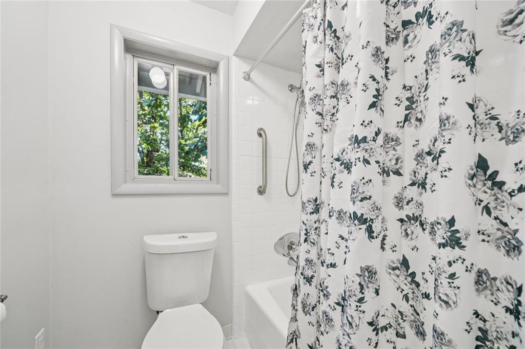 230 Lakeview Ridge East Roswell, GA 30076 - Photo 29 of 70 a white toilet sitting next to a shower curtain
