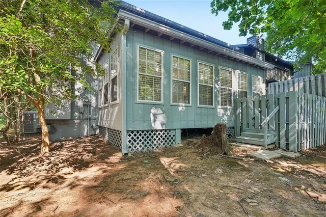 a backyard of a house with table and chairs