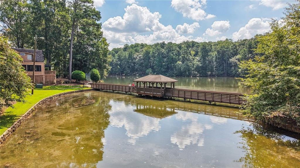 230 Lakeview Ridge East Roswell, GA 30076 - Photo 62 of 70 a view of swimming pool with outdoor seating and trees in the background