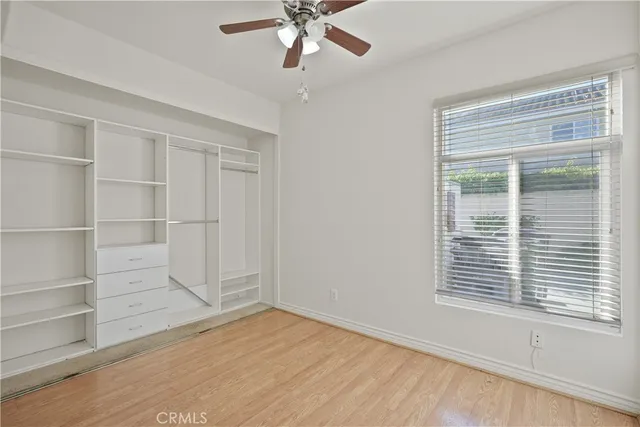 a view of a hallway with wooden floor and stairs