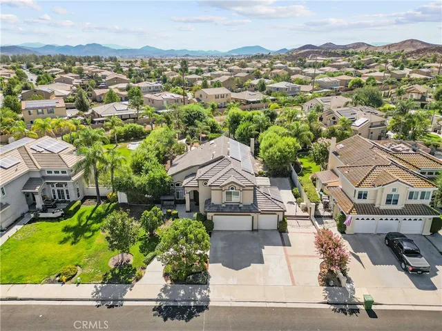 an aerial view of a house with outdoor space and swimming pool
