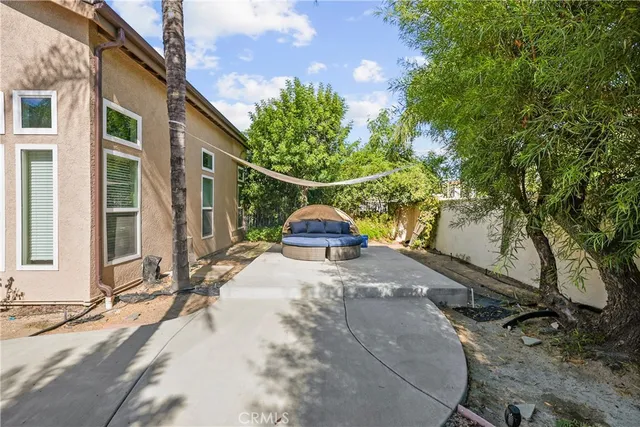 a front view of a house with a garden and patio