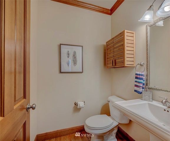 a bathroom with a toilet a sink and mirror