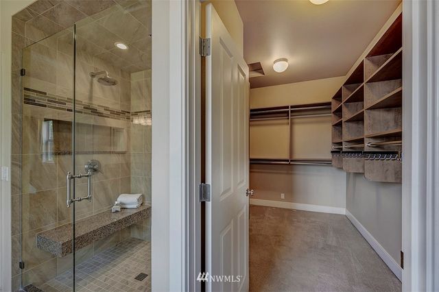 a bathroom with a shower and a glass door