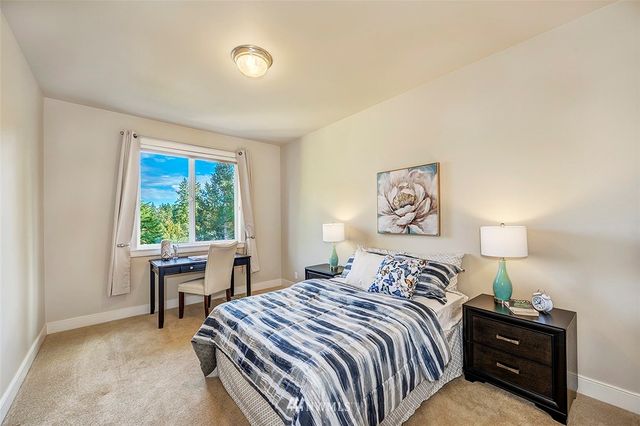 a bedroom with a bed and a table