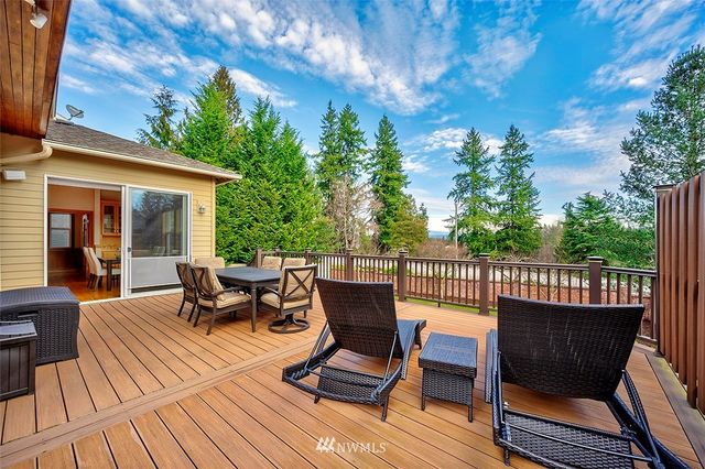 a view of a house with backyard porch and sitting area