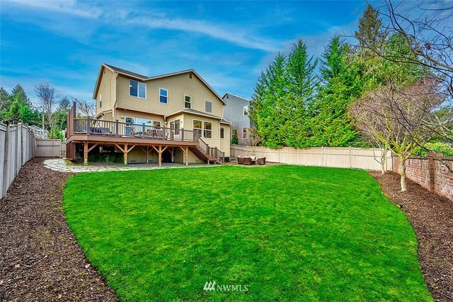 an aerial view of a house with garden space and trees