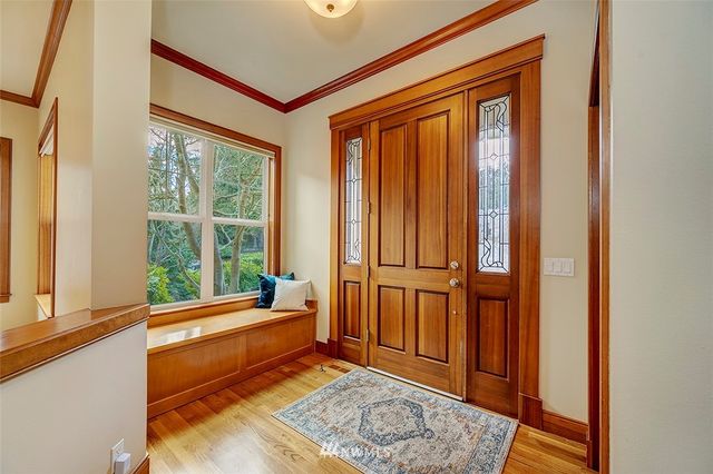 a room with large window and furniture