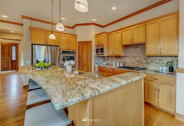 a kitchen with wooden cabinets and center island