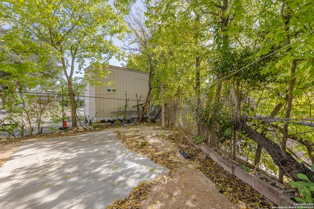 a backyard of a house with lots of trees
