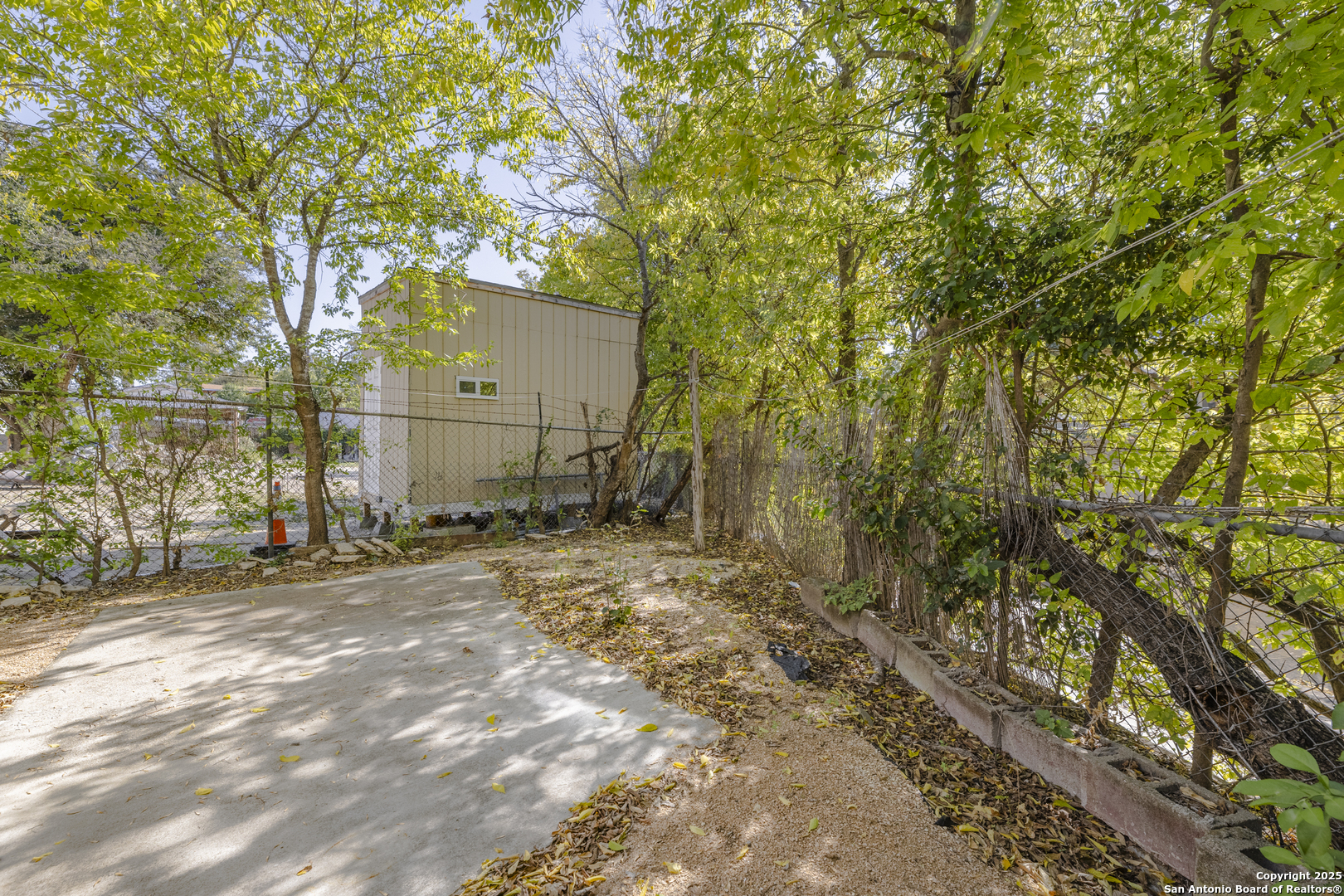 308 West Theo Avenue, Unit 2 San Antonio, TX 78214 - Photo 13 of 17 a backyard of a house with lots of trees