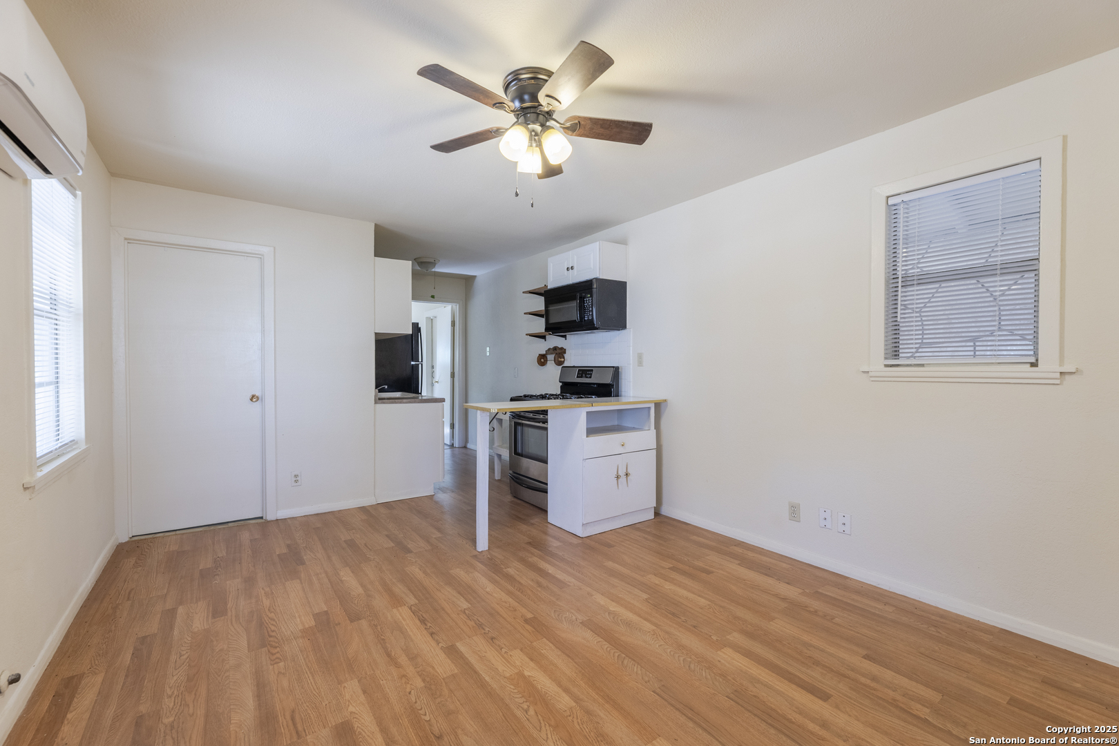 308 West Theo Avenue, Unit 2 San Antonio, TX 78214 - Photo 3 of 17 a view of a kitchen with microwave and a stove top oven