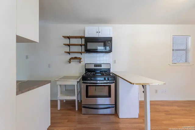 a kitchen with stainless steel appliances granite countertop a stove and a refrigerator