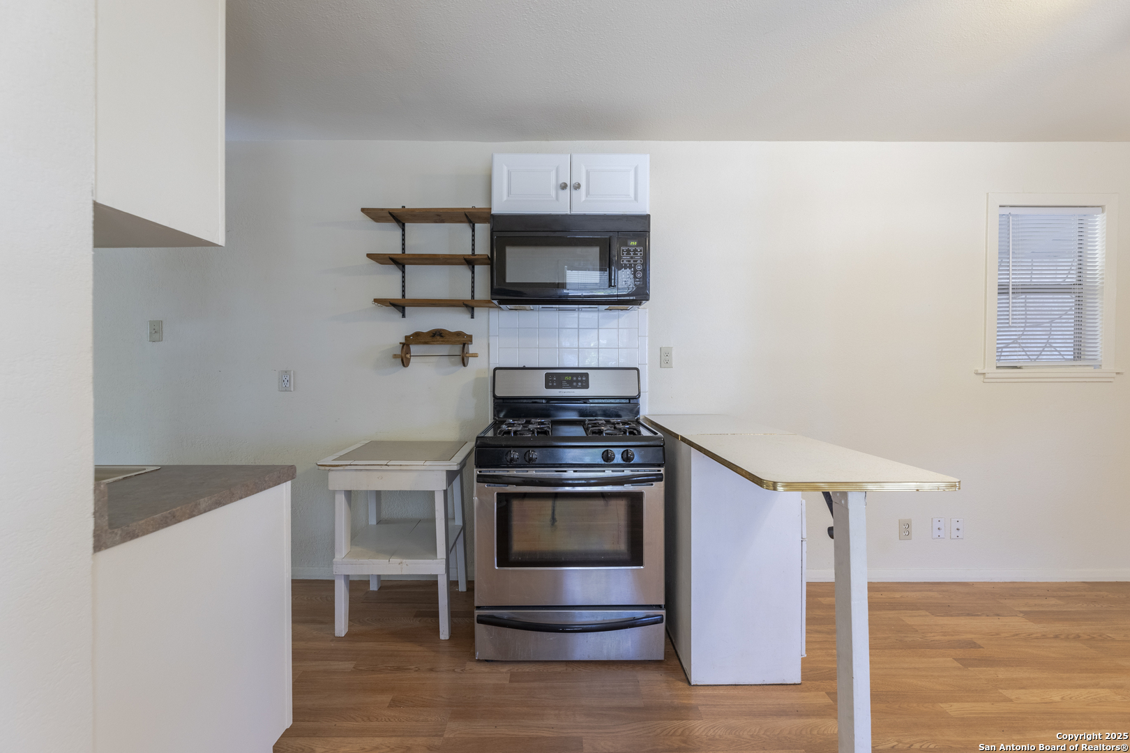 308 West Theo Avenue, Unit 2 San Antonio, TX 78214 - Photo 5 of 17 a kitchen with stainless steel appliances granite countertop a stove and a refrigerator
