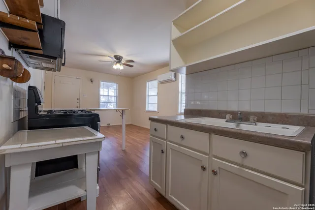 a kitchen with a sink appliances and cabinets