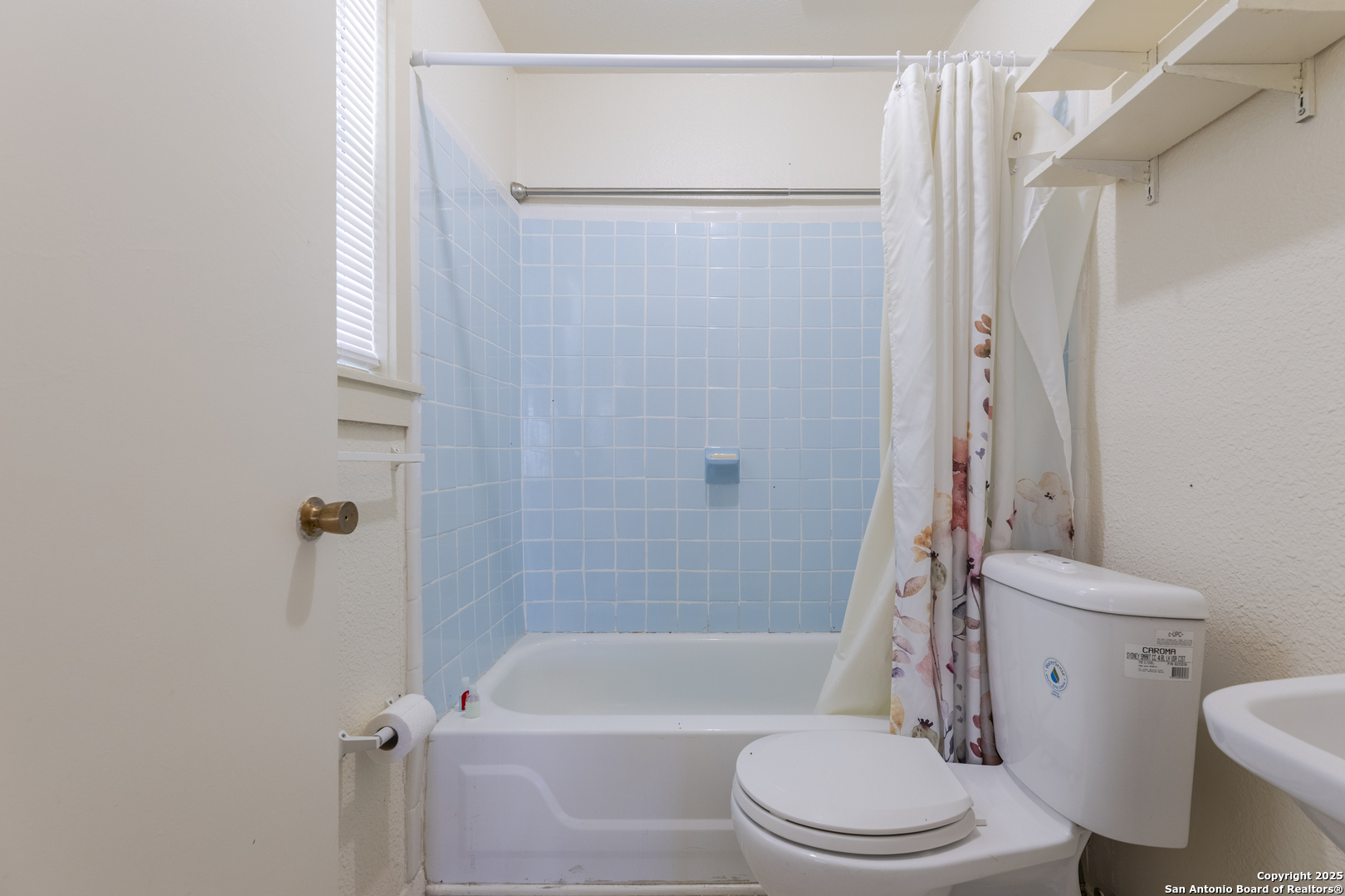308 West Theo Avenue, Unit 2 San Antonio, TX 78214 - Photo 9 of 17 a white toilet sitting next to a bath tub