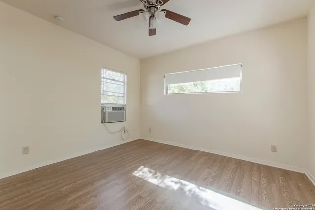 wooden floor in an empty room with a window