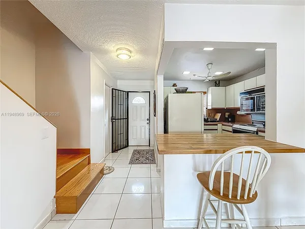 a kitchen with stainless steel appliances granite countertop a refrigerator and a stove