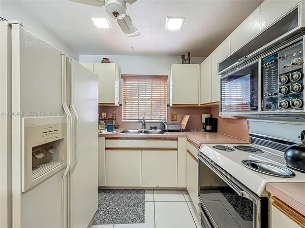 a kitchen with a sink stove and refrigerator