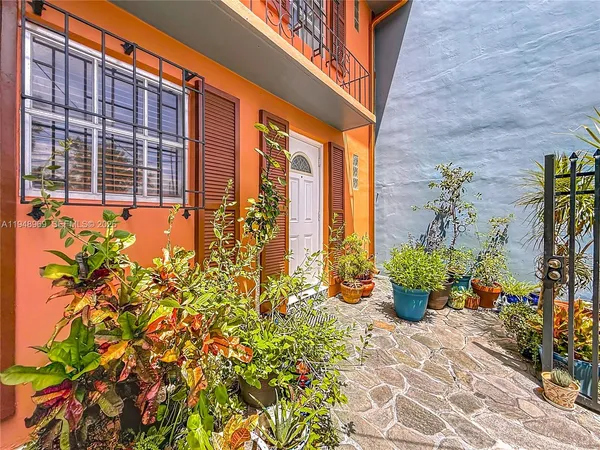 a front view of a house with outdoor seating