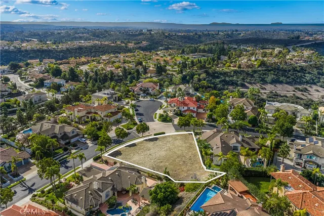 an aerial view of residential houses with outdoor space and seating